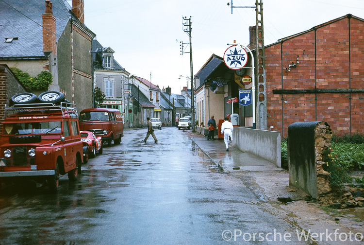 Sandwiched between the Scuderia Filipinetti Land Rover and a Porsche service vehicle in the street outside the Teloché workshop is the #35 Porsche 904 Carrera GTS