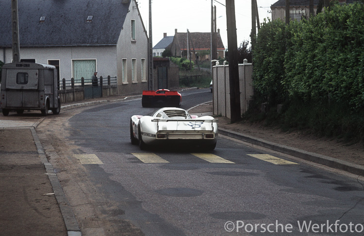 The red 917 KH Coupé leads the way through the streets of Teloché to the circuit followed by #60 Porsche 908 LH of Joest/Weber/Casoni