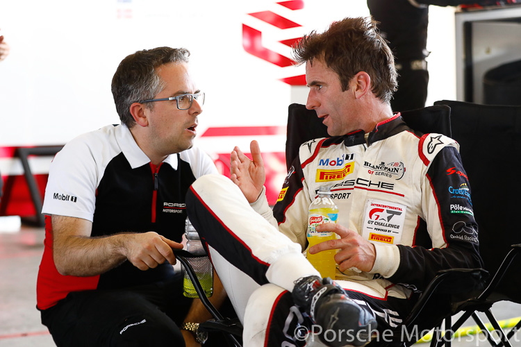 Pascal Zurlinden (Director GT Factory Motorsport) talks to Romain Dumas (#911) in the pits after his driving stint