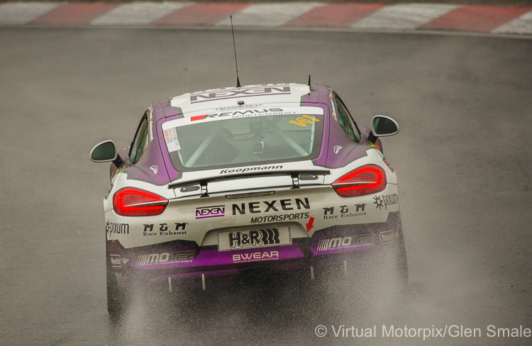 The #141 Pixum Team Adrenalin Motorsport Porsche Cayman driven by Korn/Oakes/Thorsen/Beckwermert negotiates Hatzenbach during practice (Thursday)