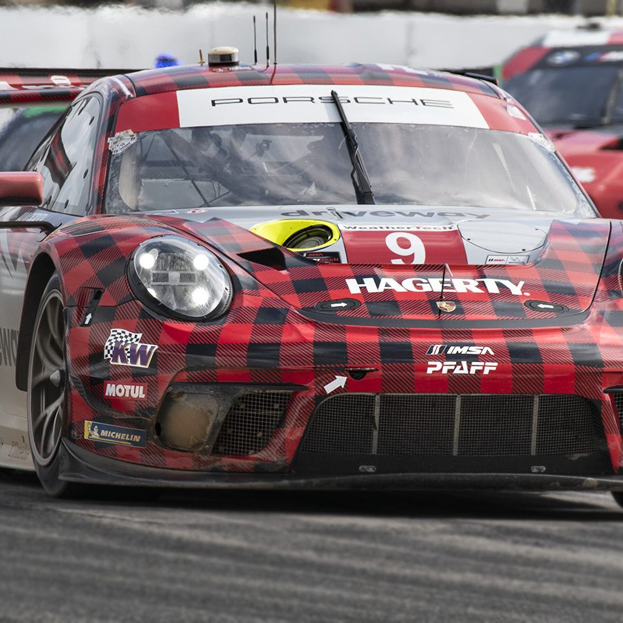 Porsche in red and black plaid livery on track at Sebring 2022