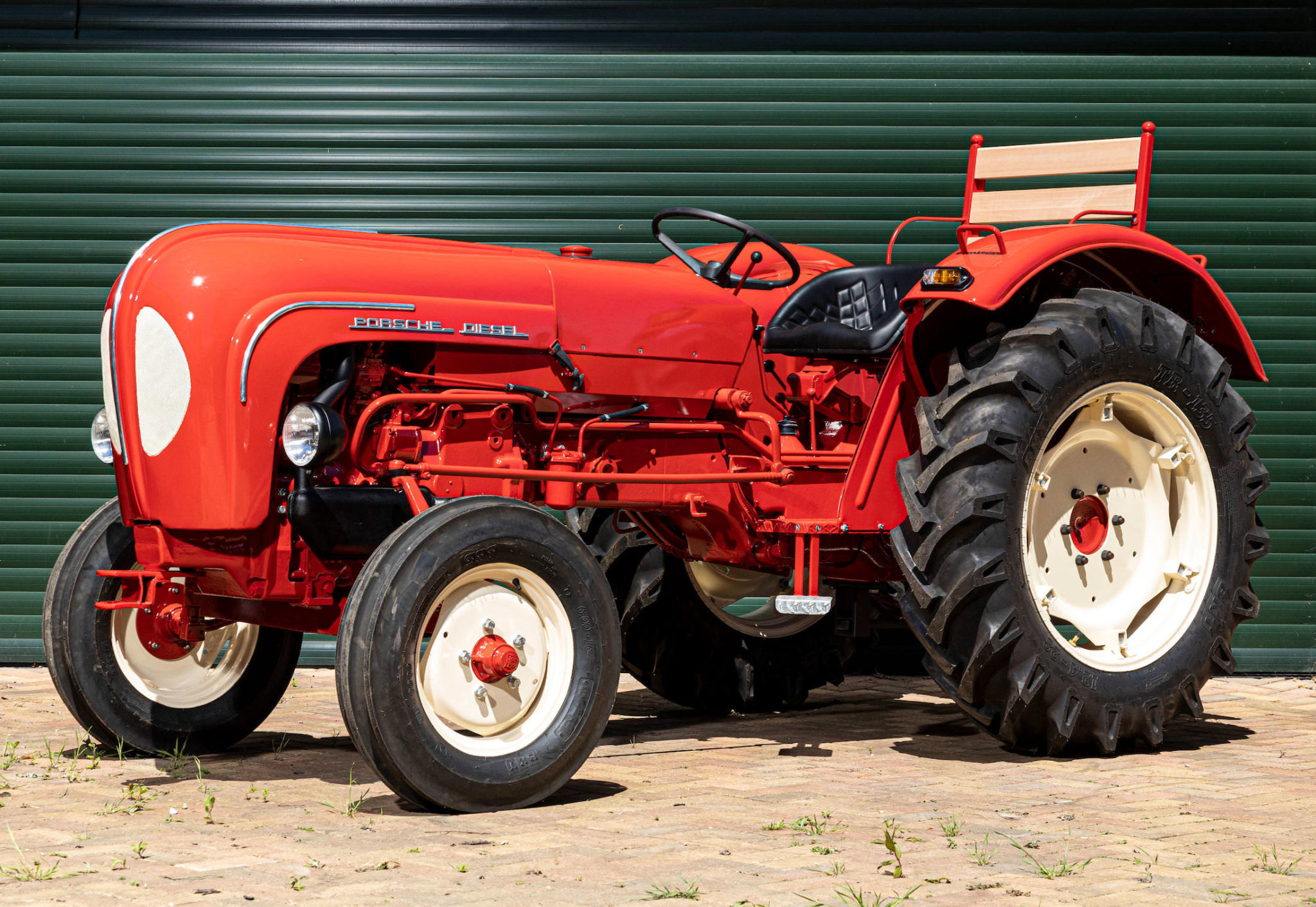 Three-quarter view of a red Porsche Tractor Model 219